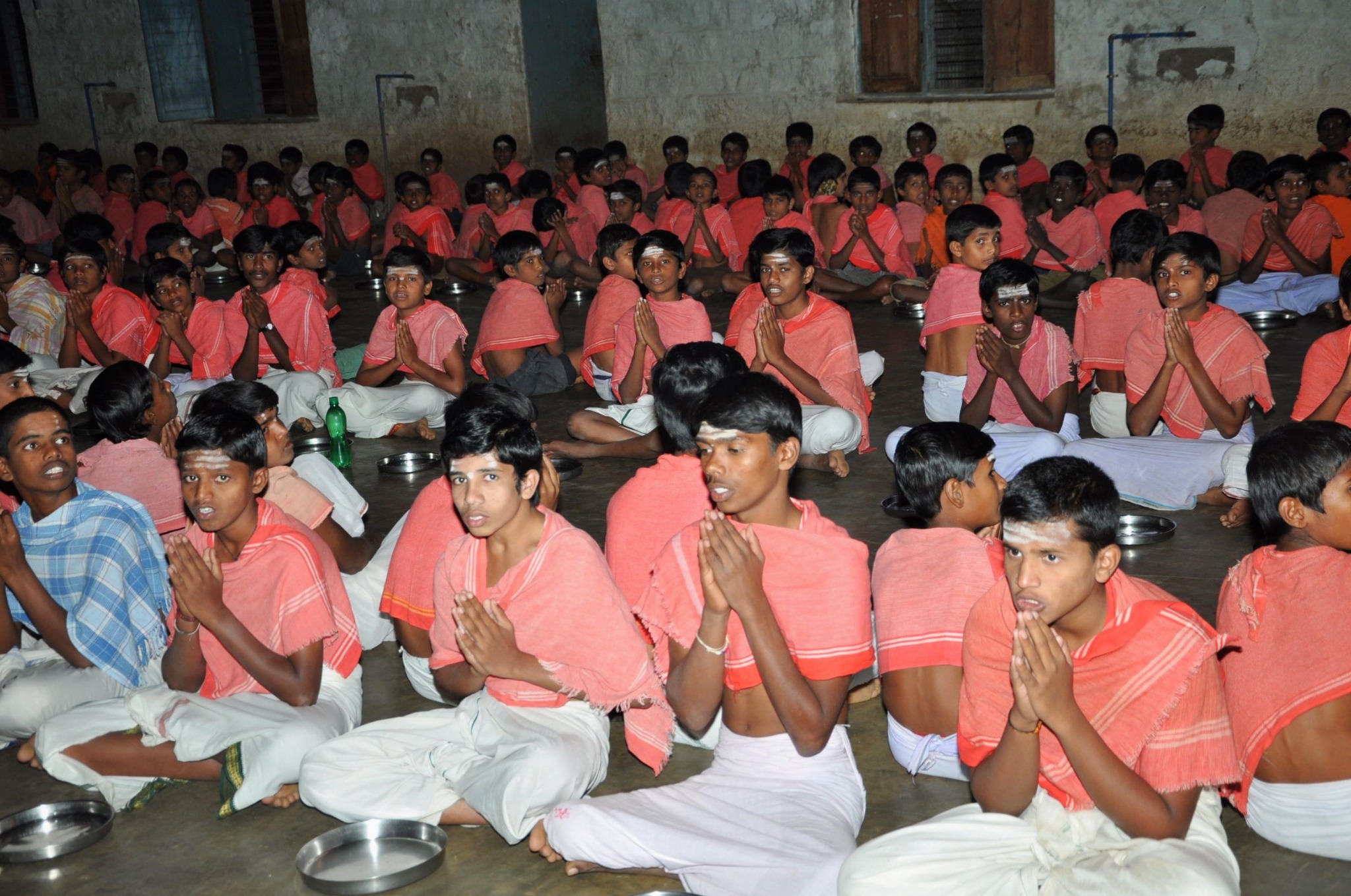 Students seated together during a group meal and prayer setting