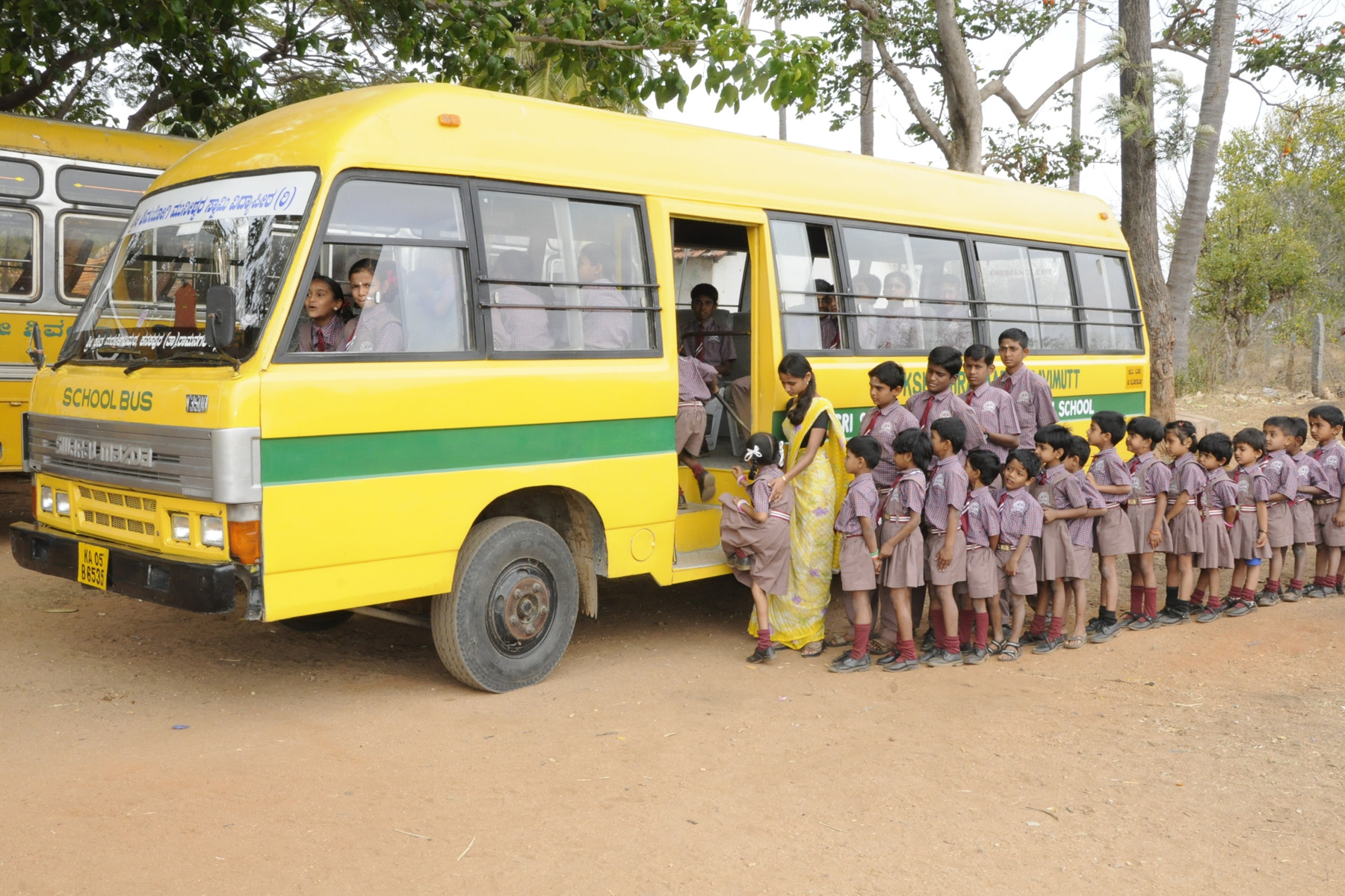 Young students boarding a school bus