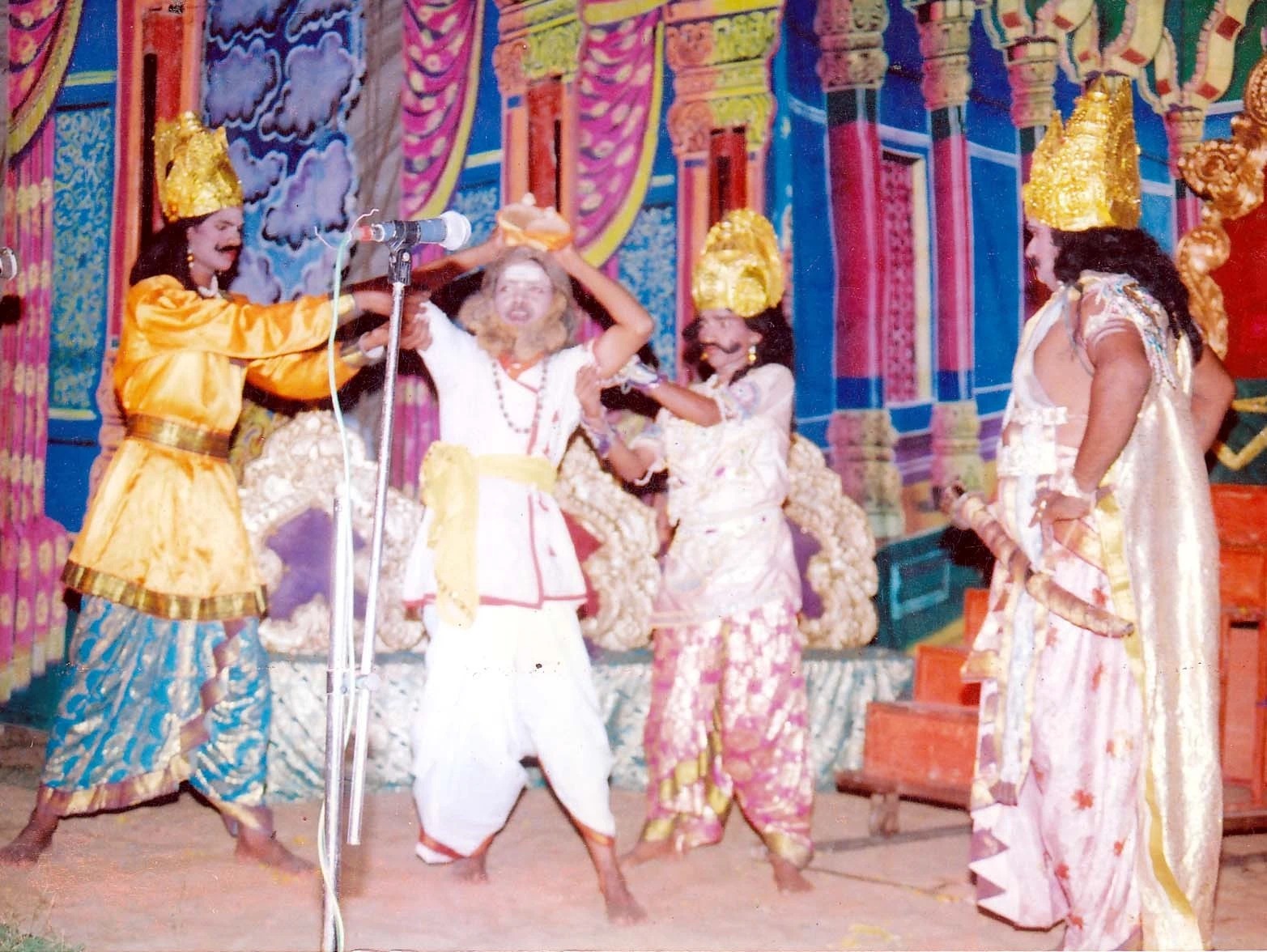 Students and participants performing a traditional dance on stage