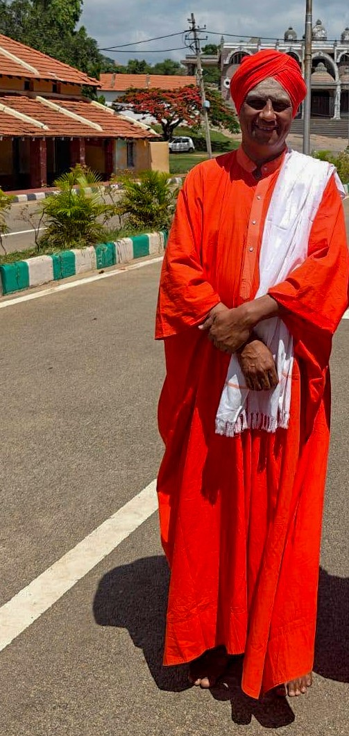 Two Swamijis walking together within the Maralegavi Mutt grounds